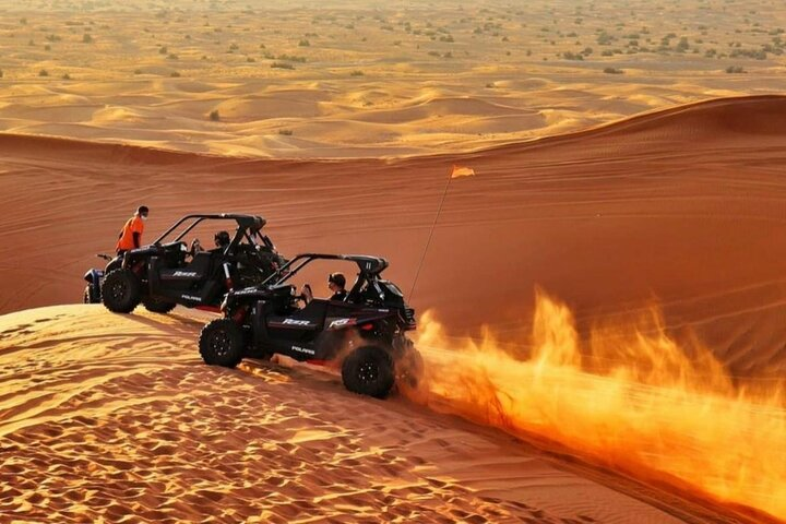 Experience the vastness of the Dubai desert while driving a powerful Polaris 1000 CC dune buggy. Navigate through stunning sand dunes creating unforgettable memories in an incredible landscape.